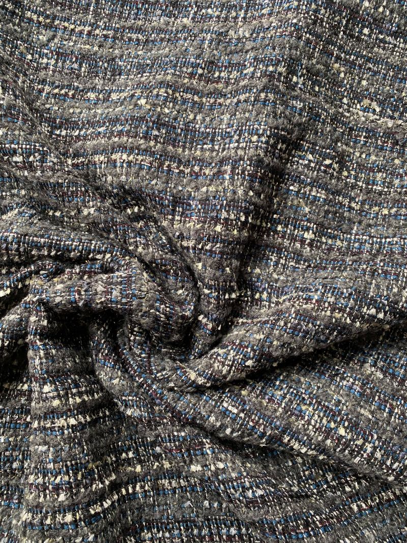 A dark grey, beige and blue tweed fabric