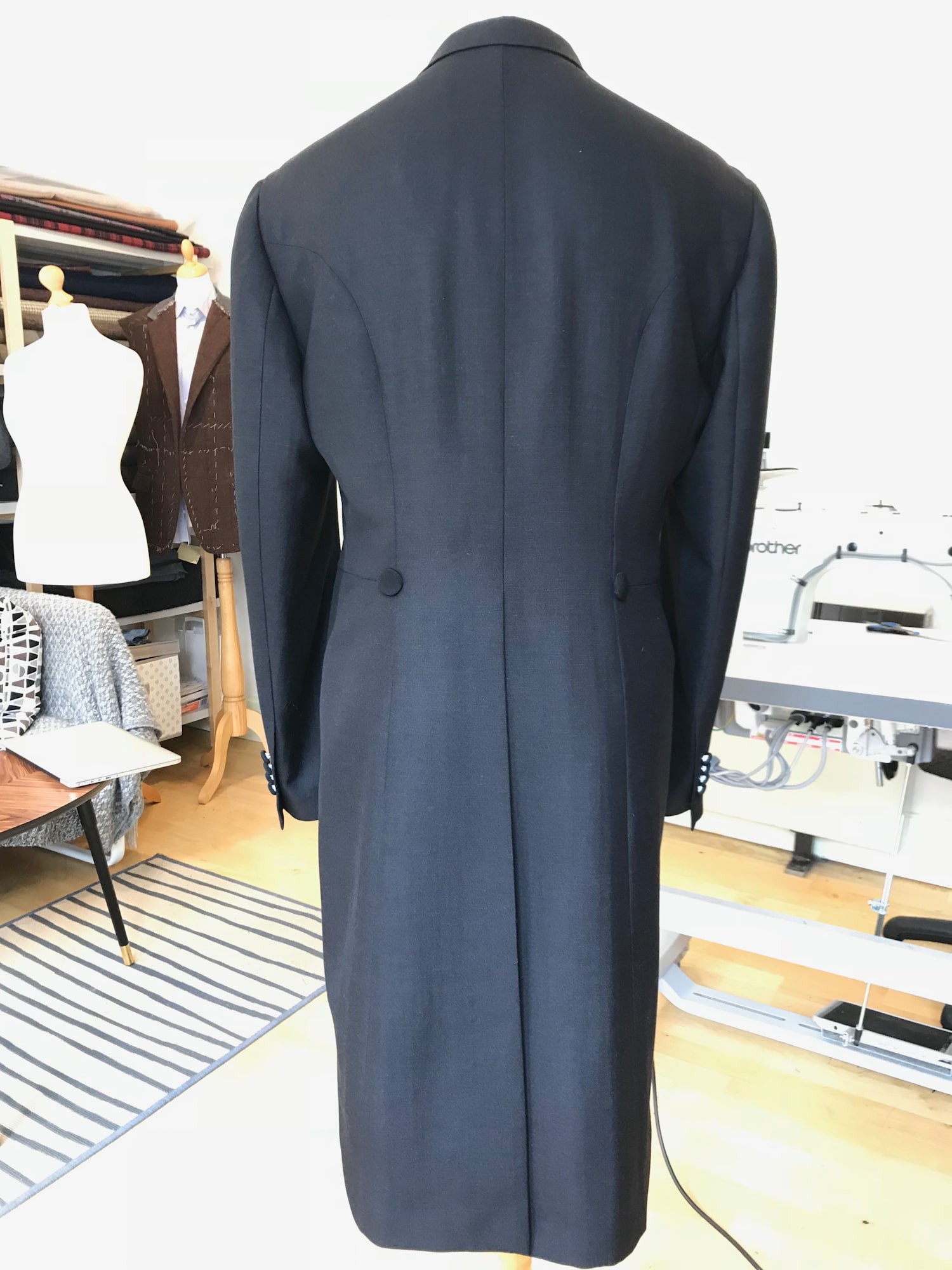 A black long suit on a mannequin